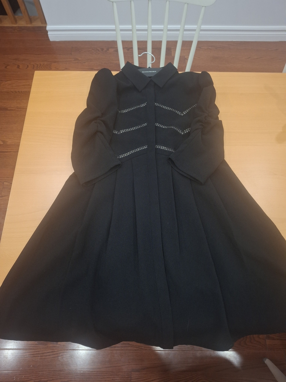 Maje Elegant Black Midi Dress with Pleated Skirt And Peekaboo Lace Detail.